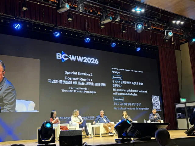Panel discussion at the BCWW 2026 special session stage featuring real-time translation guidance on the screen.